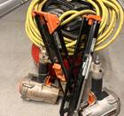 Two framing nails a hose and a pancake compressor