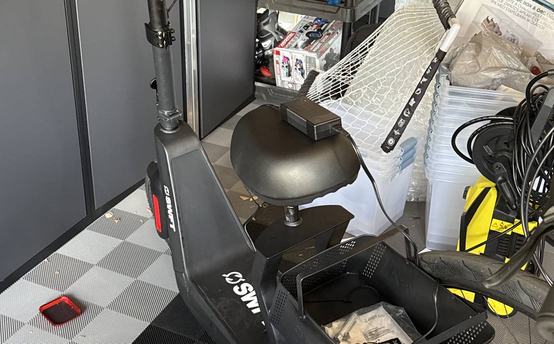 SWFT electric scooter with a seat and basket
